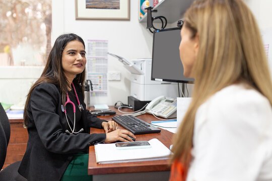 Female doctor listens to her patient in medical consultation