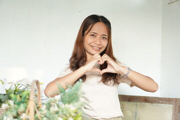 Asian woman smiling happily in a cafe