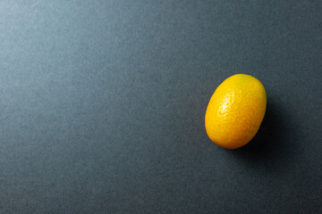 Cumquat or kumquat closeup on grey background