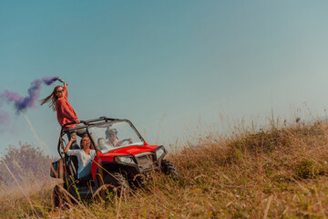 Group of young happy excited people having fun enjoying beautiful sunny day holding colorful...