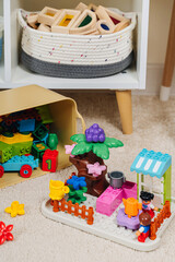 Constructors set with tree, house and people. Organizing and storage ideas in nursery.