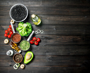 Organic food. Different raw vegetables with mushrooms and olive oil.