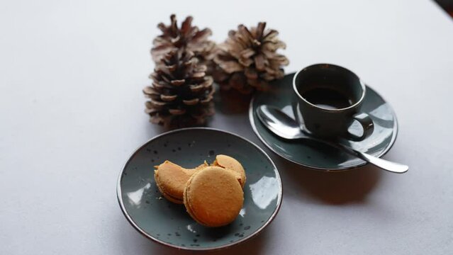 a cup of tea, baked cookies and pine cones on the table, closeup view New Year and winter concept. High quality 4k footage