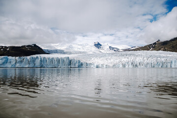 View of the glacier tongue Fjallsj&ouml;kull with its icebergs and the glacier lagoon Fjalls&aacute;rl&oacute;n in Iceland. With a view of &Ouml;r&aelig;faj&ouml;kull in the background.