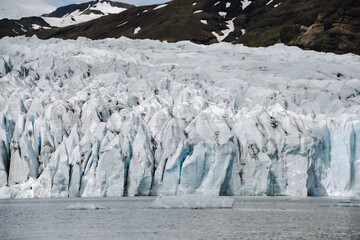 View of the glacier tongue Fjallsjökull with its icebergs and the glacier lagoon Fjallsárlón in Iceland. With a view of Öræfajökull in the background.