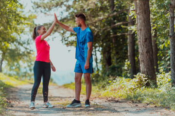 Couple enjoying in a healthy lifestyle while jogging on a country road