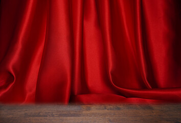 Bright red curtains are beautifully wavy, close-up.