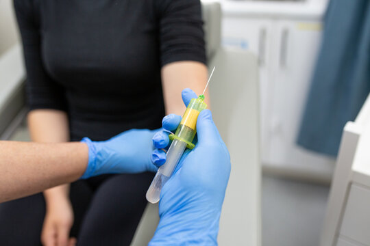 Close-up of nurse's hands taking blood from a patient