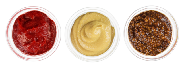 Glass Bowls of tomato ketchup and mustard and barbecue sauce