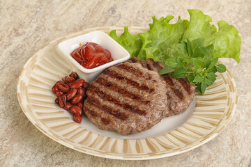 Grilled beef burger cutlet with sauce
