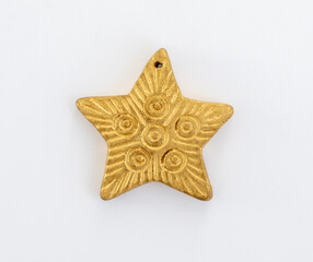Close-up of a golden star Christmas ornament