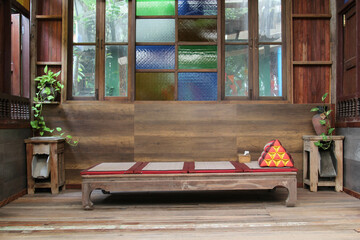 Thai style old wooden bench on the terrace.