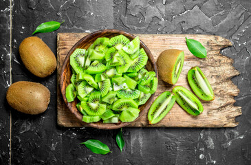 Kiwi slices in a bowl on a cutting Board.