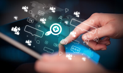 Close-up of a hand using tablet, social media concept