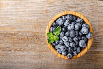 Freshly picked blueberries in a wooden bowl. Healthy berry, organic food, antioxidant, vitamin