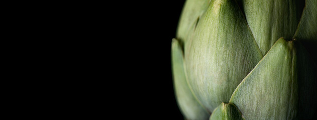 Artichoke close up. Fresh raw organic green Artichokes closeup. Isolated on black background. Healthy vegetarian food. Raw vegetables, market. Vegan backdrop. Macro border design