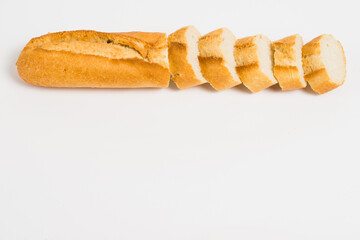 Sliced french baguette on a white background with space for text