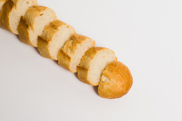 Pieces of crispy delicious French baguette on a white background