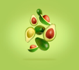 Sliced ​​and whole avocado in flight on gradient green background