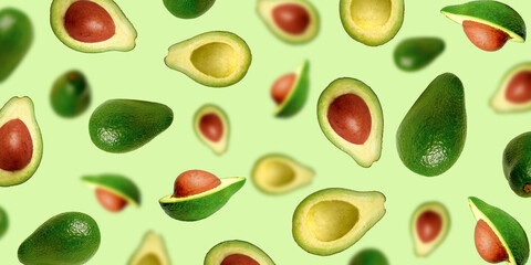 Background of juicy ripe avocados. Levitating avocados on a light green background