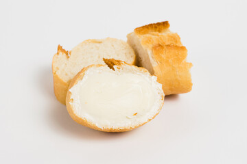 Pieces of baguette with an appetizing crust with butter, on a white background, macro. Concept of healthy eating.