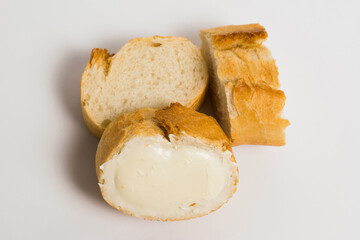 Pieces of baguette with an appetizing crust with butter, on a white background, macro. Concept of healthy eating.