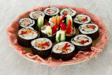 Homemade futomaki maki sushi rolls with vegetables and canned tuna fish.