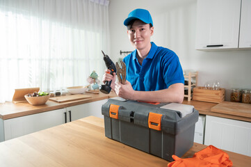 An Asian young Technician service man wearing blue uniform checking electrical appliances in home