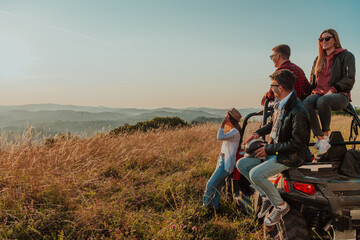 Group young happy people enjoying beautiful sunny day while driving a off road buggy car on...