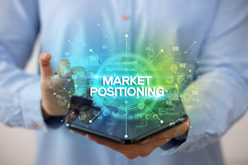 Businessman holding a foldable smartphone, new business concept