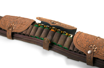 Old hunting cartridges and bandoleer on a wooden table