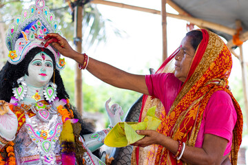 Local rural Woman worshipping godess in the village