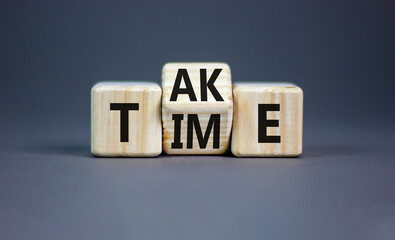 Take your time symbol. Concept word Take Time on wooden cubes. Beautiful grey table grey...