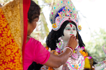 Local rural Woman worshipping godess in the village