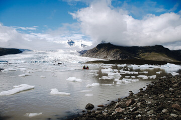 View of the glacier tongue Fjallsjökull with its icebergs and the glacier lagoon Fjallsárlón in Iceland. With a view of Öræfajökull in the background.