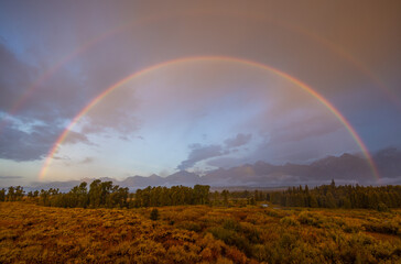 Obraz na płótnie Canvas Storm Clouds and Rainbow over the Tetons in Autumn