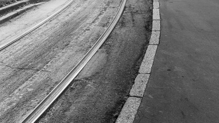 Monochromatic view of tramway tracks on asphalt in Milan, Italy. Monochromatic.
