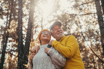 Head shot portrait close up of middle age cheerful people smiling and looking at the the trees of...