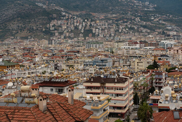 Fototapeta premium Aerial view of rooftops of the crowded city of Alanya on the Turkish Coast, Turkey.