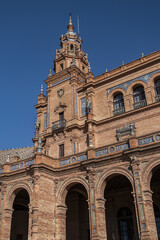 Architectural details of the picturesque renaissance and Moorish building styles in the Spain square (Plaza de Espana). Seville, Andalusia, Spain.