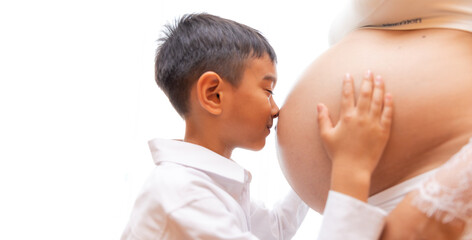 Young boy is kissing the pregnant woman isolated on white background