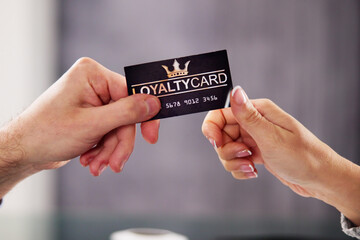 Businessman's Hand Giving Loyalty Card