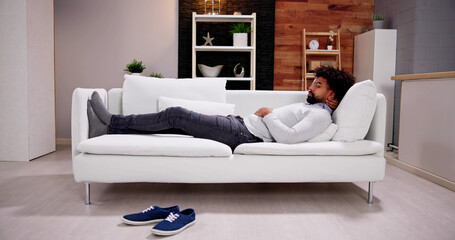 African American Man Relaxing On Sofa