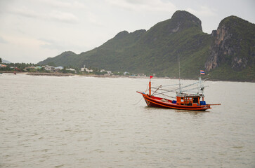 Coastal fishing boats are floating by the sea.