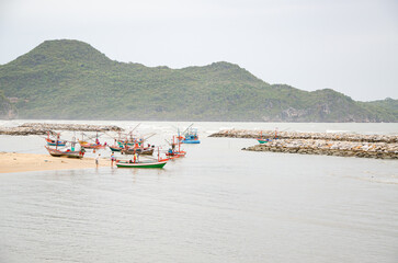 Coastal fishing boats are floating by the sea.