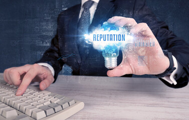 Businessman holding a light bulb, business concept