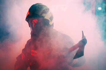 firefighter holding an axe in a smoke