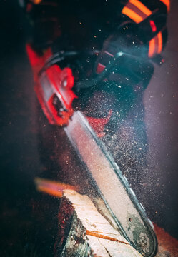 A firefighter using a hacksaw.