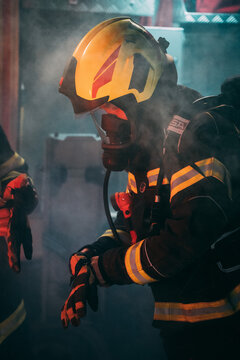 A firefighter taking equipment surrounded with a smoke.