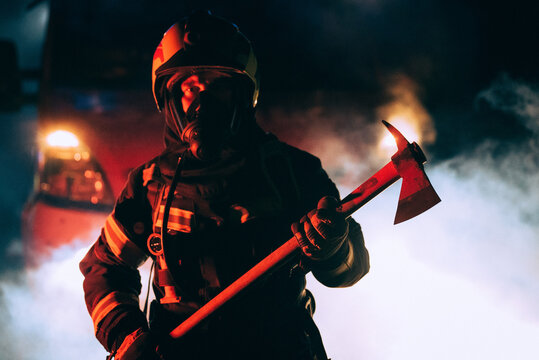 firefighter holding an axe in a smoke